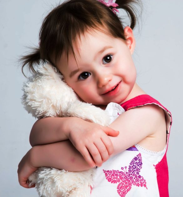 petite fille serre son doudou contre elle