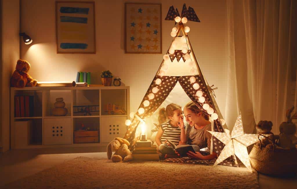 enfant et sa mère joue sous une tente dans une chambre d'enfant
